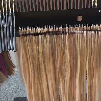 Nano-bond hair strands hung ready on the fitting trolley.