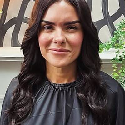 A client with long dark-brown waves after her fitting.