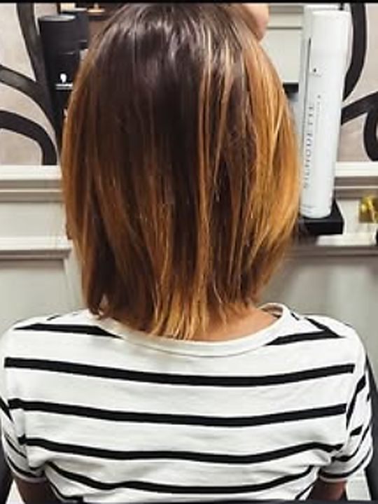 Before: a client's own hair, a shoulder-length bob with grown-out bleached ends, photographed from behind in the salon.